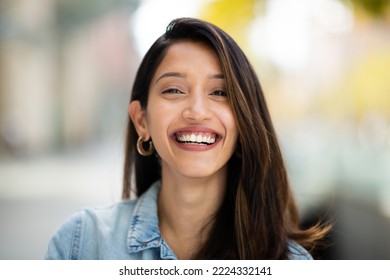 Close up front portrait beautiful woman laughing outdoors  - Shutterstock ID 2224332141