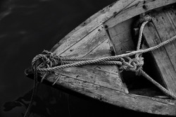 Close Up Of Front Side Of Small Fisherman Boat Moored In Port. Small Row Boat Floating , View From Top Angle Black And White Photography