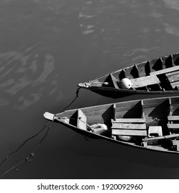 Close Up Of Front Side Of Small Fisherman Boat Moored In Port. Small Row Boat Floating , View From Top Angle Black And White Photography