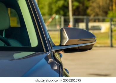 Close up front view of car side mirror. Front rear view mirror on the car window. Car exterior details.