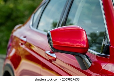 Close Up Front View Of Car Side Mirror. Front Rear View Mirror On The Car Window. Car Exterior Details. Red Car Mirror.