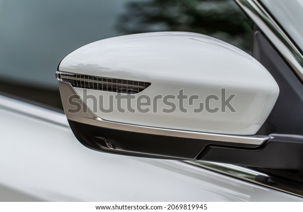 Close up front view of car\
side mirror. Front rear view mirror on the car window. Car exterior\
details.