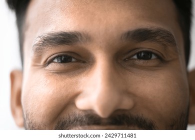 Close up front view face of happy millennial Indian brown-eyed man having attractive appearance optimistic mood, smile, looking at camera, advertising eye-care, vision correction, eyeglasses and lens - Powered by Shutterstock