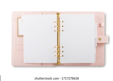 A close up front view of an open daily light pink calendar with gold rings isolated on a white background.