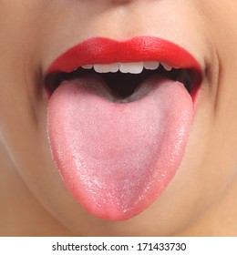 Close up of a front view of a woman tongue and red painted lips        