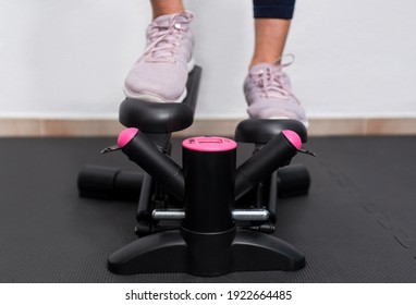 Close Up Front View Of Woman Training On A Stair Climbers Machine.