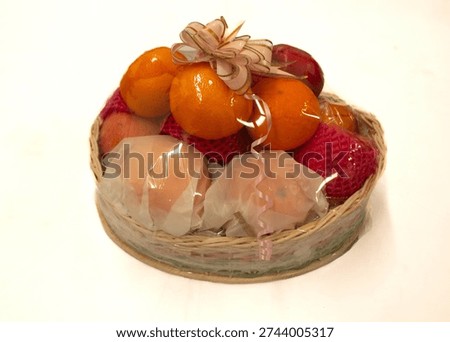 Close up of fruit parcel isolated on clean background, showcasing assorted fresh fruits arranged for gift hamper or festive celebration.