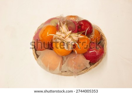 Close up of fruit parcel isolated on clean background, showcasing assorted fresh fruits arranged for gift hamper or festive celebration.