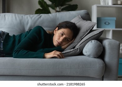 Close Up Frustrated Woman Lying On Couch Alone, Feeling Depressed And Lonely, Thinking About Relationships Or Personal Problems, Hopeless Young Female Lost In Thoughts, Suffering From Break Up