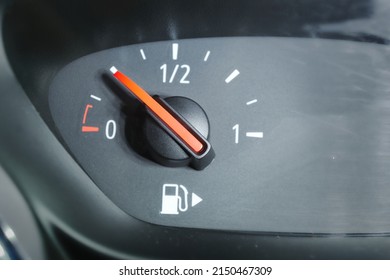 A close up of a fuel gauge showing a quarter full fuel tank in a car, gasoline consumption  - Powered by Shutterstock