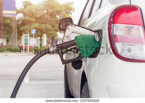 Close up of fuel monitoring system refueling\
a petroleum to vehicle at gas\
station