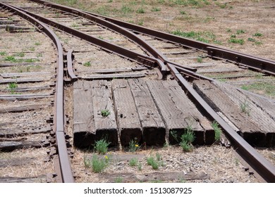 Close full frame view of a segment of a switch in the railroad and a crossing path