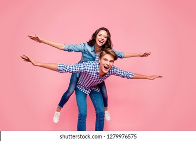 Close Up Full Length Body Size Photo Of Piggy Back Hug She Her He Him His Lady Guy Hands As Wings Pretending Flight Wearing Casual Jeans Denim Plaid Shirts Isolated On Rose Background