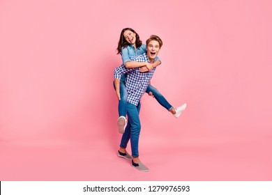 Close up full length body size photo of piggy back hugging she her he him his lady guy boy going to competitions best team wearing casual jeans denim plaid shirts isolated on rose background - Powered by Shutterstock