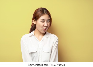 Close Up Of Funny Asian Young Woman In Stylish White Shirt Looking In Camera With Raised Eyebrows And Surprised Face Expression.