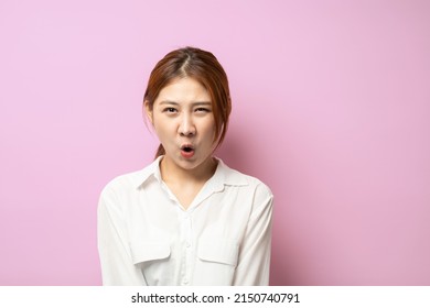 Close Up Of Funny Asian Young Woman In Stylish White Shirt Looking In Camera With Raised Eyebrows And Surprised Face Expression.