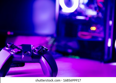 Close Up Of A Game Pad And A Glass Pc Case With Purple Lighting 