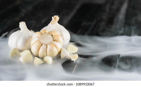 Close up garlic on wood, black isolate back ground