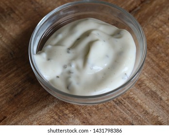 close up of garlic sauce in a glass bowl, on a wooden background - Shutterstock ID 1431798386