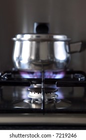 Close Up Of A Gas Hob With A Pan On The Back Burner, Shallow DOF.