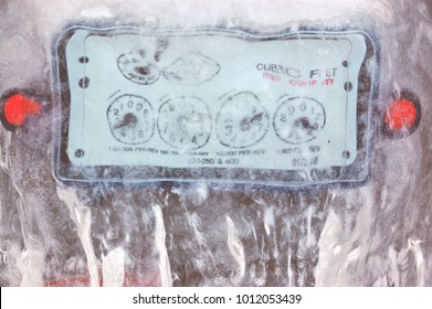 Close Up Gas Meter Dials Covered And Encased In Ice, Winter Utility Bills Background 