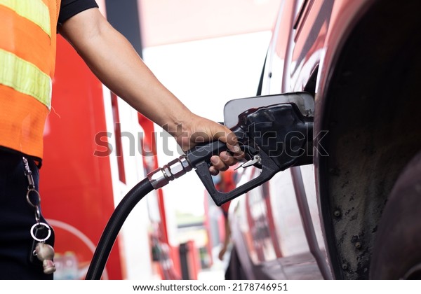 Close up Gas Station worker\
fill fuel or gasoline to vehicle, Refueling Car With Gasoline Pump\
Nozzle