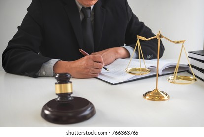 Close up of gavel, Male lawyer or judge working with Law books, report the case on table in modern office, Law and justice concept.