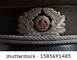 Close up of GDR badge on a Stasi officer