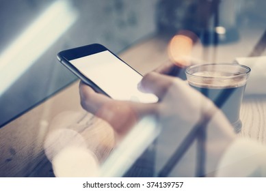 Close Up Of Generic Design Smart Phone Holding In Female Hands For Texting Message. Cup Coffee On The Table. Horizontal