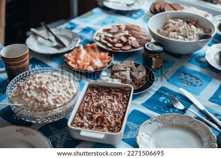 close up of generously covered table with homemade dishes, covered with a tablecloth, on which there are various delicious dishes of Estoninan cuisine