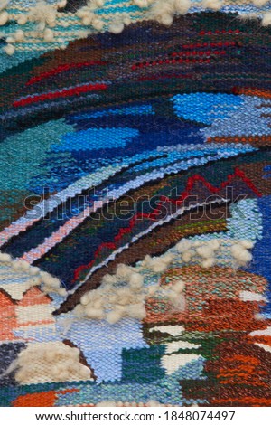 Close up of geometric patterned carpet. Hand woven rug with red, yellow, blue and other colors. Hand woven carpet with abstract design. Colorful carpet. Textile background. Abstract background. 