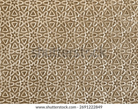 Close up of geometrical flower shape pattern cutouts in metallic gold paint finish. 3D cutout laser cut floral shapes suitable for screens or divider. Seamless background texture.