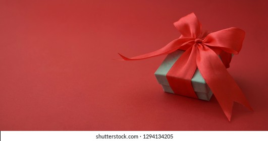 Close up gift box, birtday gift with red bow on red background. Love, Valentine's Day, Mother's Day. Banner. - Shutterstock ID 1294134205