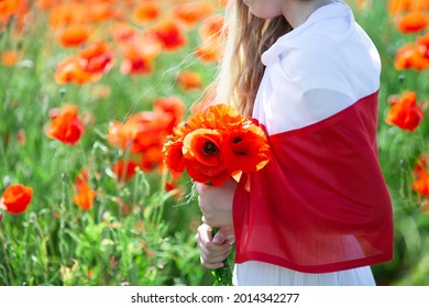 Close up of girl covered with flag of Poland holding bouquet of poppies in the poppy field. Polish Flag Day. Independence Day. Love Poland concept. - Shutterstock ID 2014342277