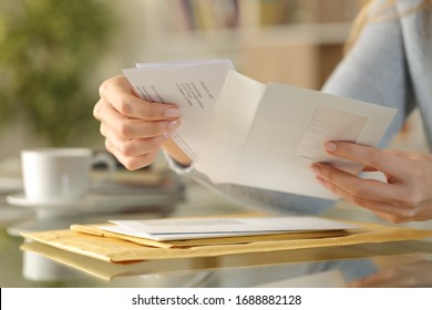 Close Up Of Girl Hands Opening An Envelope With A Letter Inside On A Desk At Home
