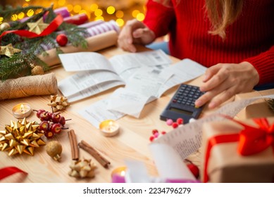 Close up of girl looking through checks of christmas expenses. Checks from stores for presents and decorations bought for christmas