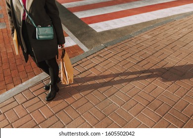 Close up of a girl pedestrian with yellow book after shopping in the store - Shutterstock ID 1605502042