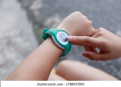 Close Up Girl Using Smartwatch Touching Button And Touchscreen On Active Sports. Finger Touch Button On Smarth Watch. Girl Set Smart Watch Before Running On Road.