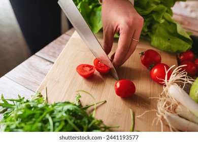 A close up of girl's or woman's hands peeling and cutting vegetables with knife making salad	
 - Powered by Shutterstock