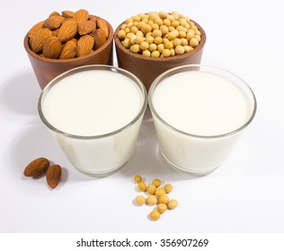 Close Up Of A Glass Of Almond And Soy Milk On A White Background.