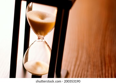 Close Up Of The Glass Bulbs On An Hourglass Or Egg Timer With Running Sand Measuring Passing Time In A Countdown Or Deadline