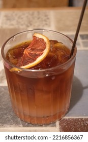 Close Up Of A Glass Of Cold Brew Coffee Served With A Dried Grapefruit 