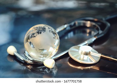 Close Up Glass Global And Stethoscope On Table, World Health Day, Medical And Healthcare, Life Insurance Business Technology, 2019-ncov Risk And Problem, Coronavirus Covid-19 Warning Concept