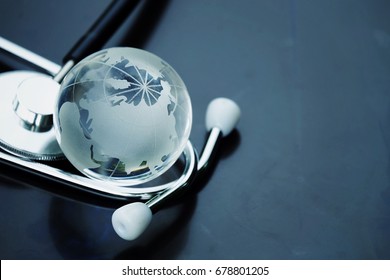 Close Up Glass Global And Stethoscope On Table With Copy Space Background, World Health Day, Medical And Healthcare, 2019-ncov Risk And Problem, Coronavirus Covid-19 Warning, Global Pandemic Concept