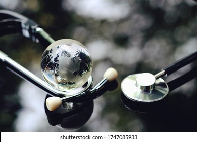 Close Up Glass Globe And Stethoscope On Table, World Health Day, Medical And Healthcare, 2019-ncov Risk And Problem, Coronavirus Covid-19warning, Global Pandemic And Telemedicine Business Technology