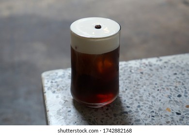 Close Up Glass Of Iced Cold Brew Coffee Topped With Cream Cheese