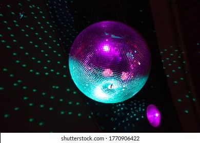 Close Up Of A Glitzy Disco Ball Reflection Light Onto A Black Ceiling On A Dance Floor