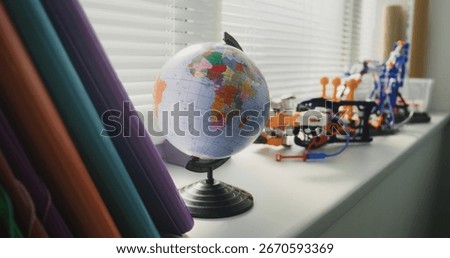 Close Up of Globe and STEM Building Set Models Standing near Window in Modern Primary School Classroom. Creative Space for Children Studying and Education, Development of Imagination and Creativity.