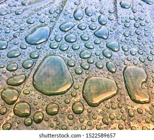 Close Up Of Globules Of Rain Water On A Plastic Cover For Garden Furniture After A Heavy Shower