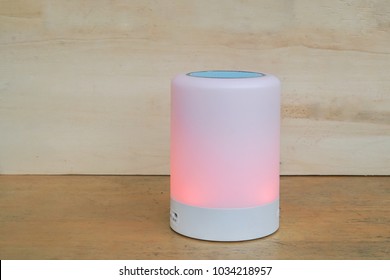 Close Up Glow Speaker In Light Red Color And Modern Wireless Speaker For Listening To Music By Bluetooth